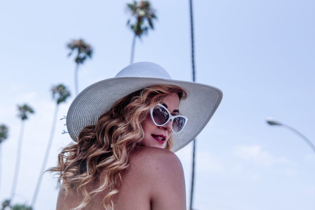 Photo of Shari Sirotnak in sunglasses and a white hat